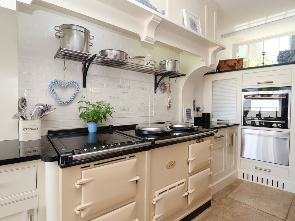 A kitchen with a stove and utensils holder at Marina