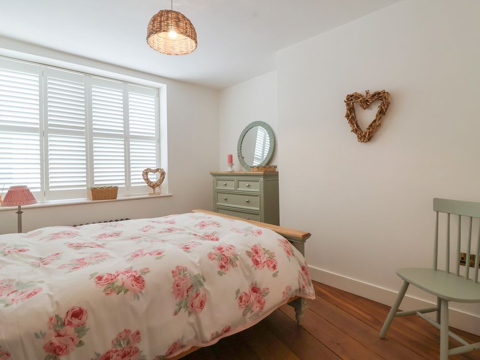 A bedroom with a bed and dresser at Marina 