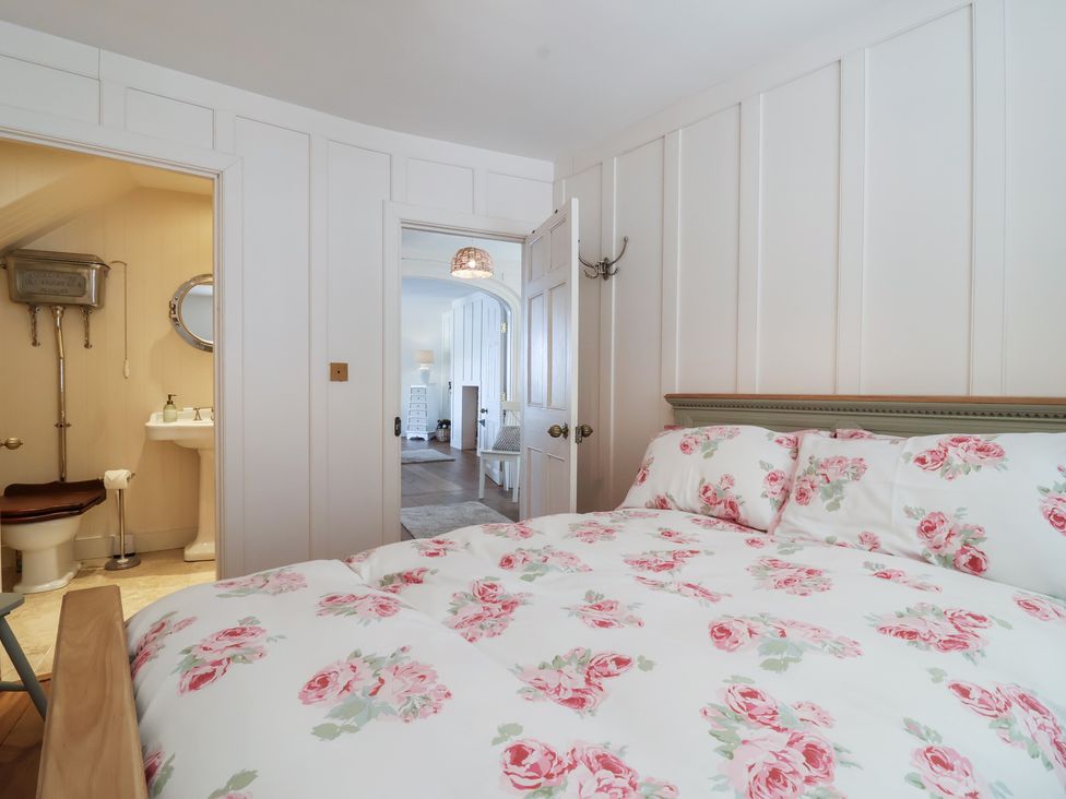 A bedroom with a bed and visible bathroom at Marina