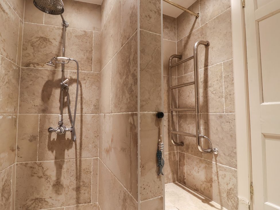 A bathroom with shower and grab bars at Marina