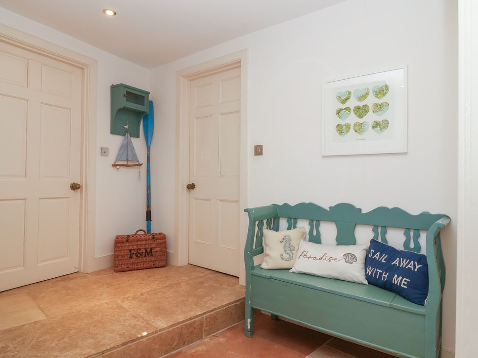 A hallway with a bench and decorative items at Marina