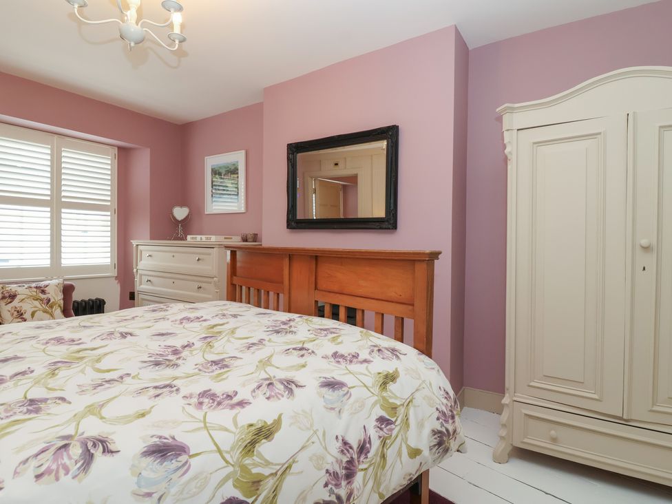 A bedroom with a bed, wardrobe, and dresser at Marina