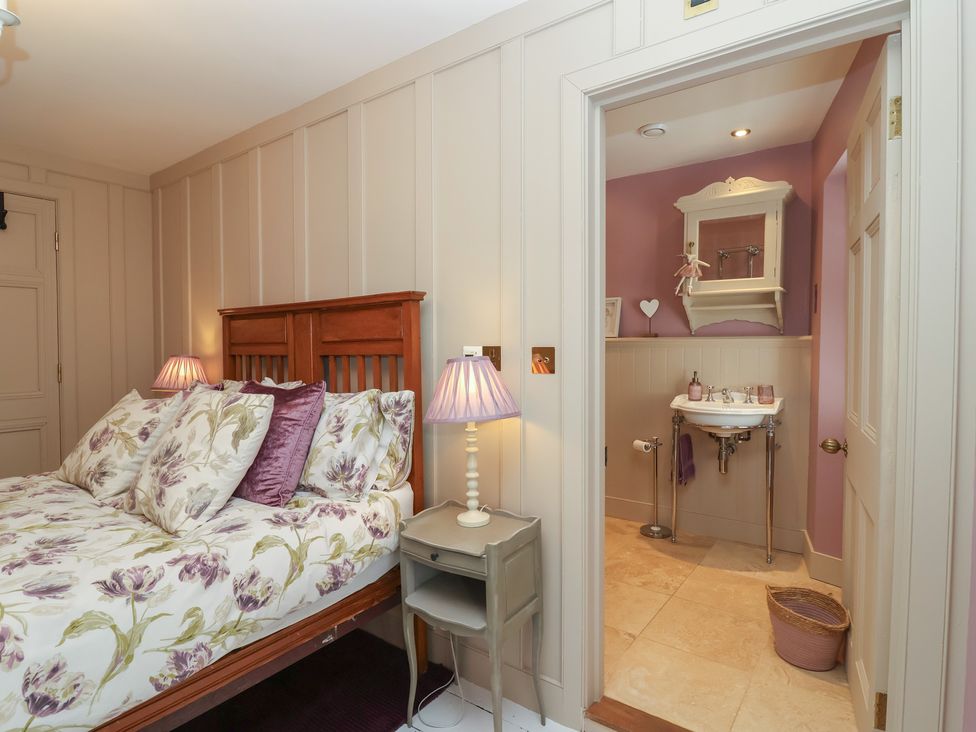 A bedroom with a bed and adjoining bathroom at Marina