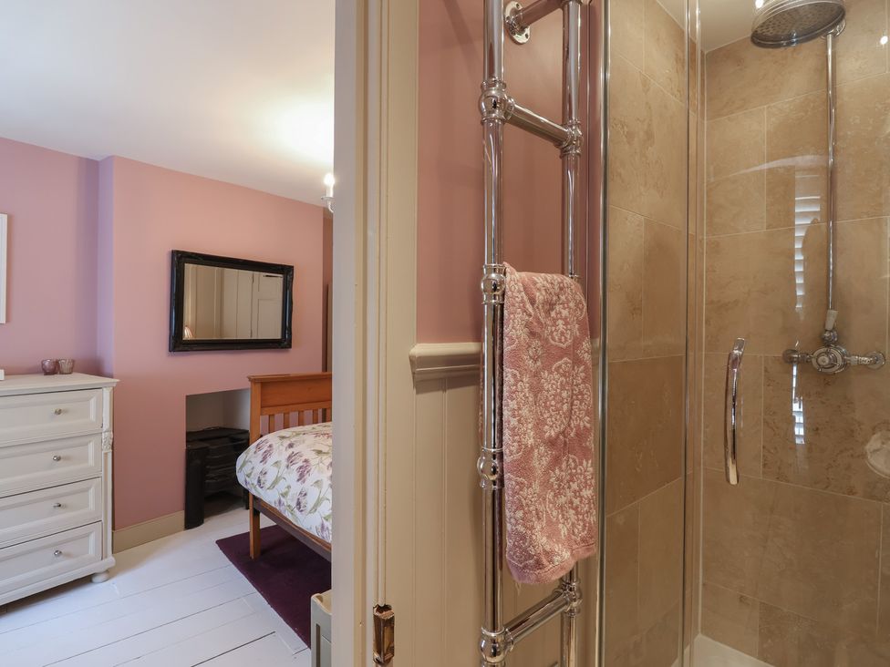 A bathroom with a shower and towel rail at Marina