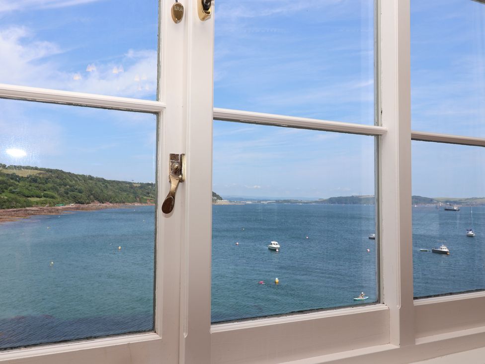 A view of the sea with boats through a window at Marina