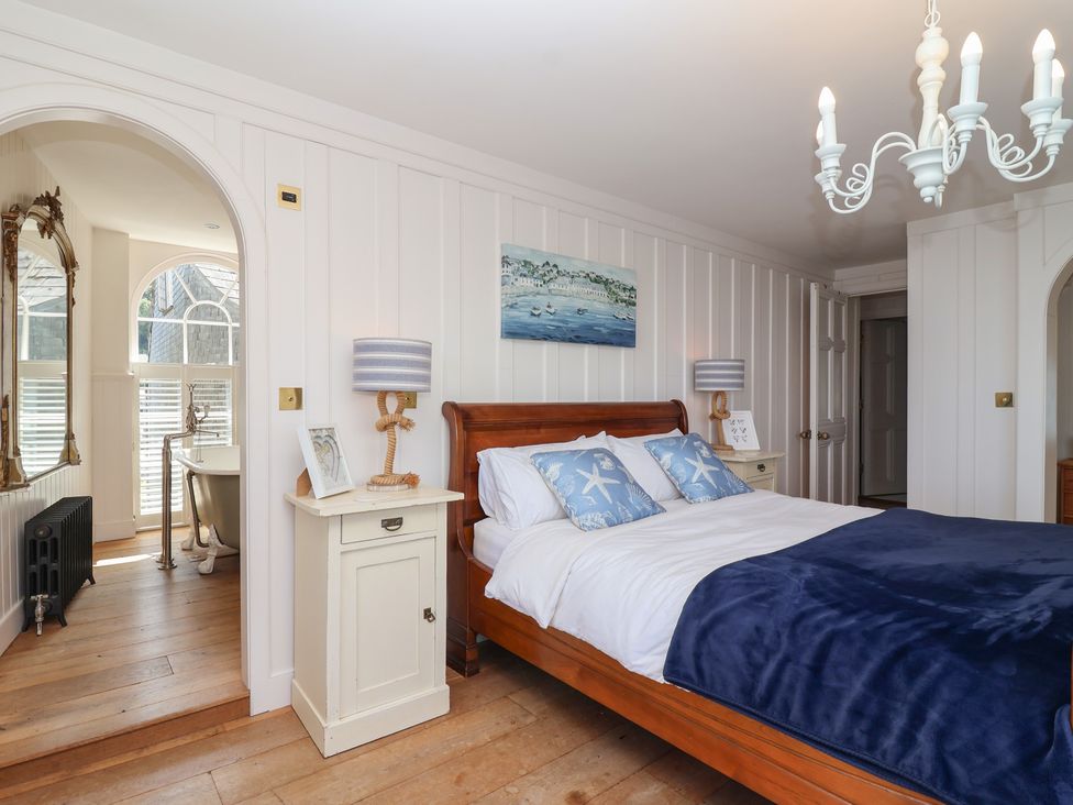 A bedroom with a bed and a mirror at Marina