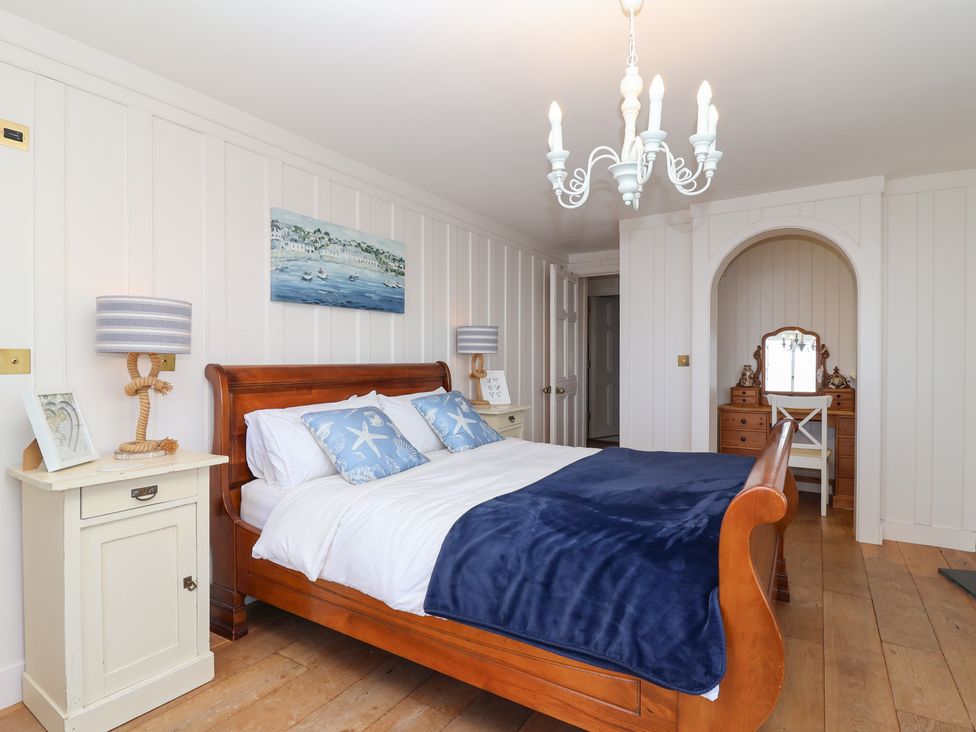 A bedroom with a bed and dressing table at Marina