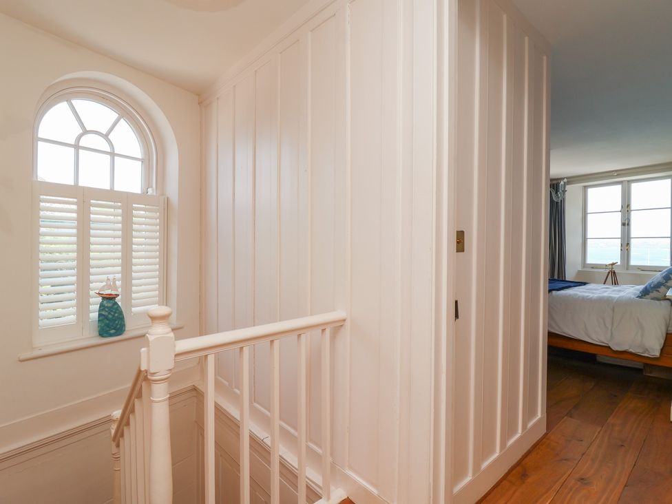 A staircase leading to a bedroom with a window and door at Marina in 