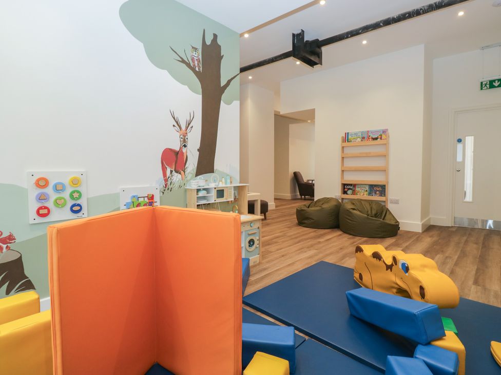 A playroom with soft play equipment and a bookshelf at Apartment 1 in Keswick