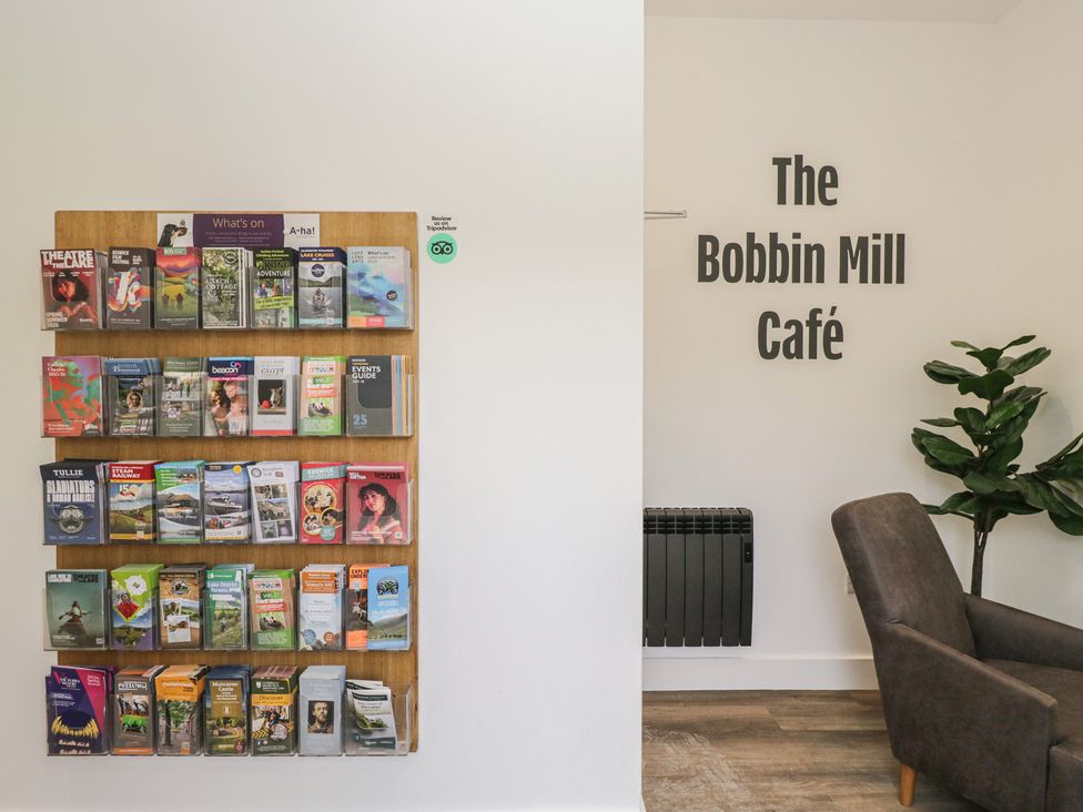 A brochure display and a chair at The Bobbin Mill Café in Keswick