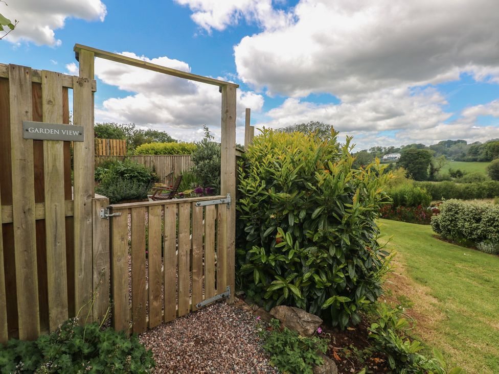 A garden with a wooden gate and sign at Garden View in Pembroke
