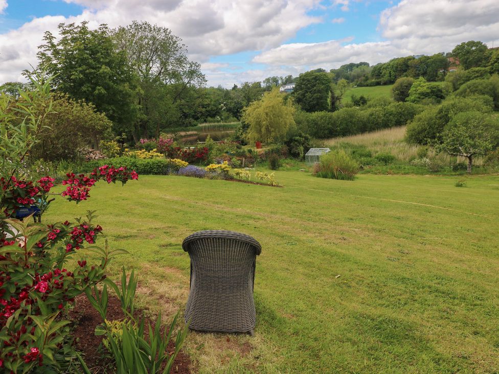 A garden with a chair and flowers at Garden View in Pembroke