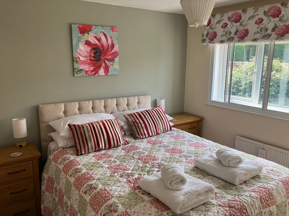 A bedroom with a bed and window at Ludlow House in Ludlow