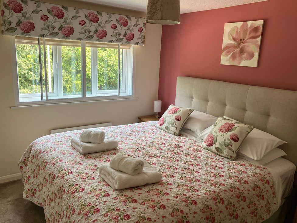 A bedroom with a bed and window at Ludlow House in Ludlow