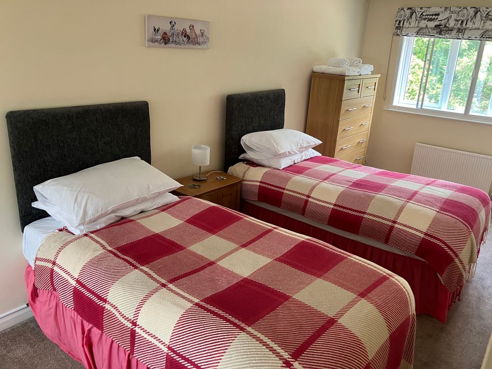 A bedroom with two beds and a chest of drawers at Ludlow House in Ludlow