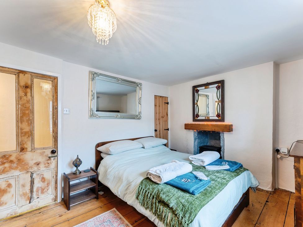 A bedroom with a bed and bedside table at Rivendell in Ffynnongroyw