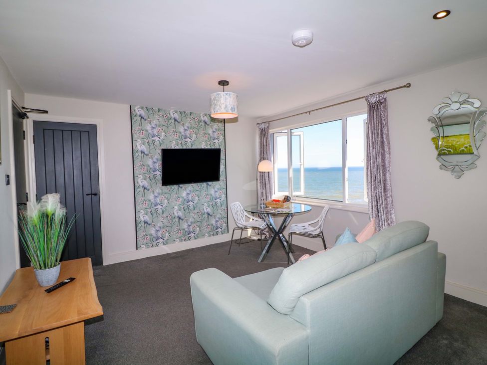 A living room with a sofa and dining table at Apt 7 @ Hunter's Quay in Bridlington