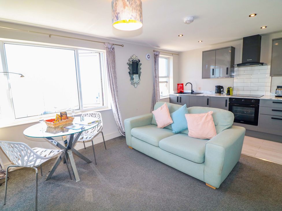 A living room with a sofa and dining table at Apt 7 @ Hunter's Quay in Bridlington