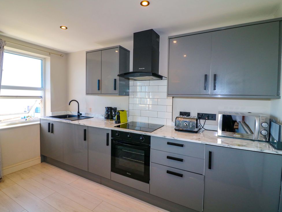 A kitchen with a sink and cooking appliances at Apt 7 @ Hunter's Quay in Bridlington