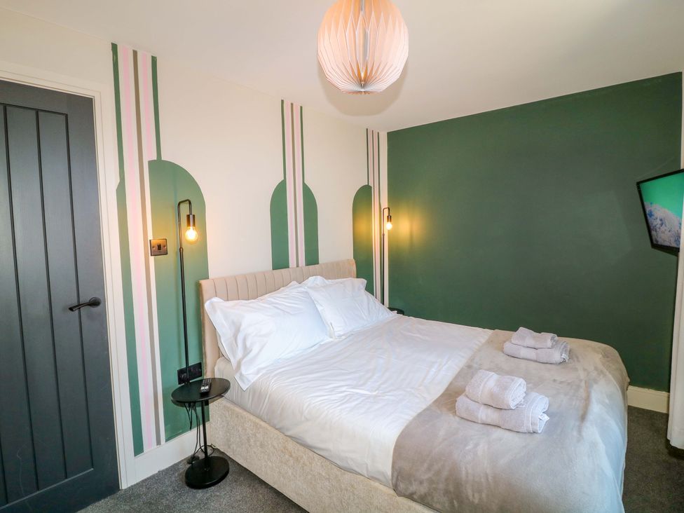 A bedroom with a bed and towels on it at Apt 7 @ Hunter's Quay, Bridlington