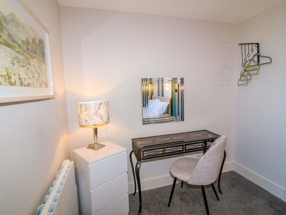 A bedroom with a desk and lamp at Apt 7 @ Hunter's Quay in Bridlington