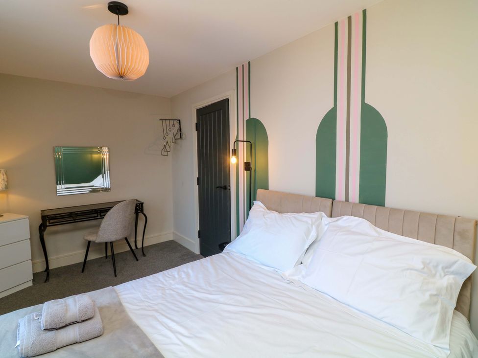 A bedroom with a bed and desk at Apt 7 @ Hunter's Quay Bridlington