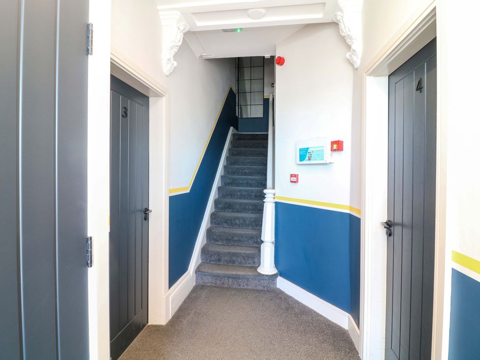A hallway with doors and a staircase at Apt 7 @ Hunter's Quay Bridlington