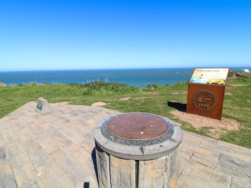 A viewing point overlooking the sea with an information board at Flamborough Head in Bridlington