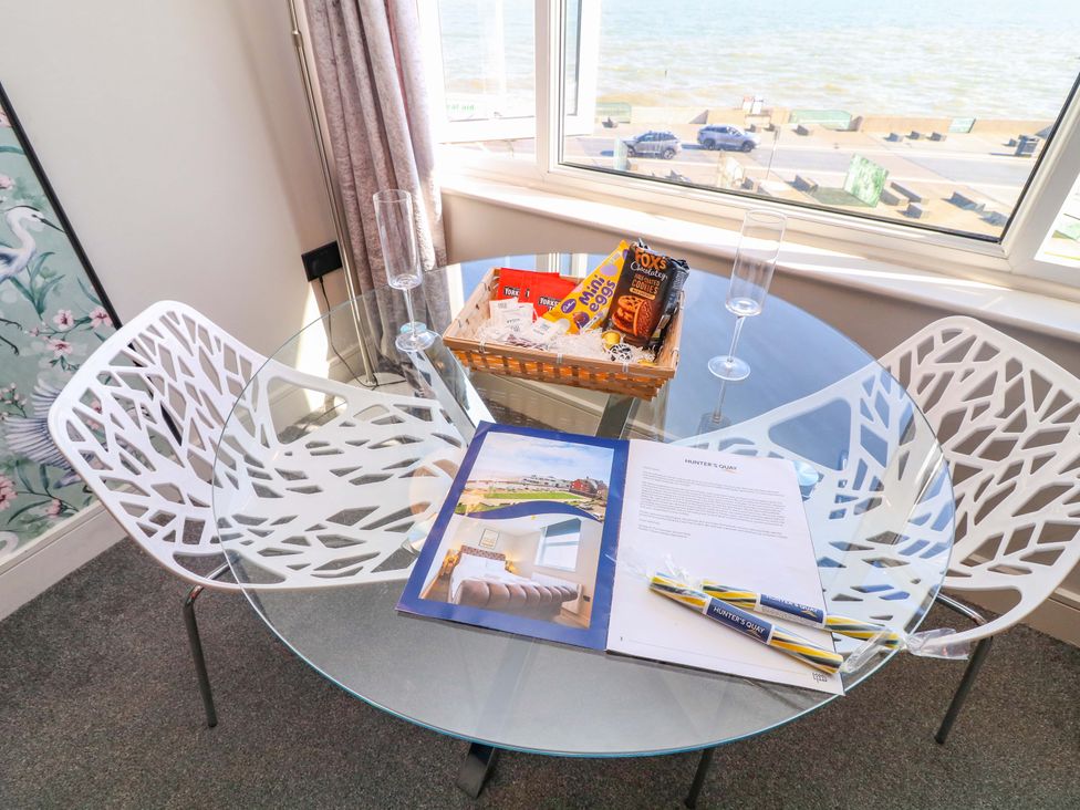 A dining room with a glass table and chairs at Apt 7 @ Hunter's Quay Bridlington