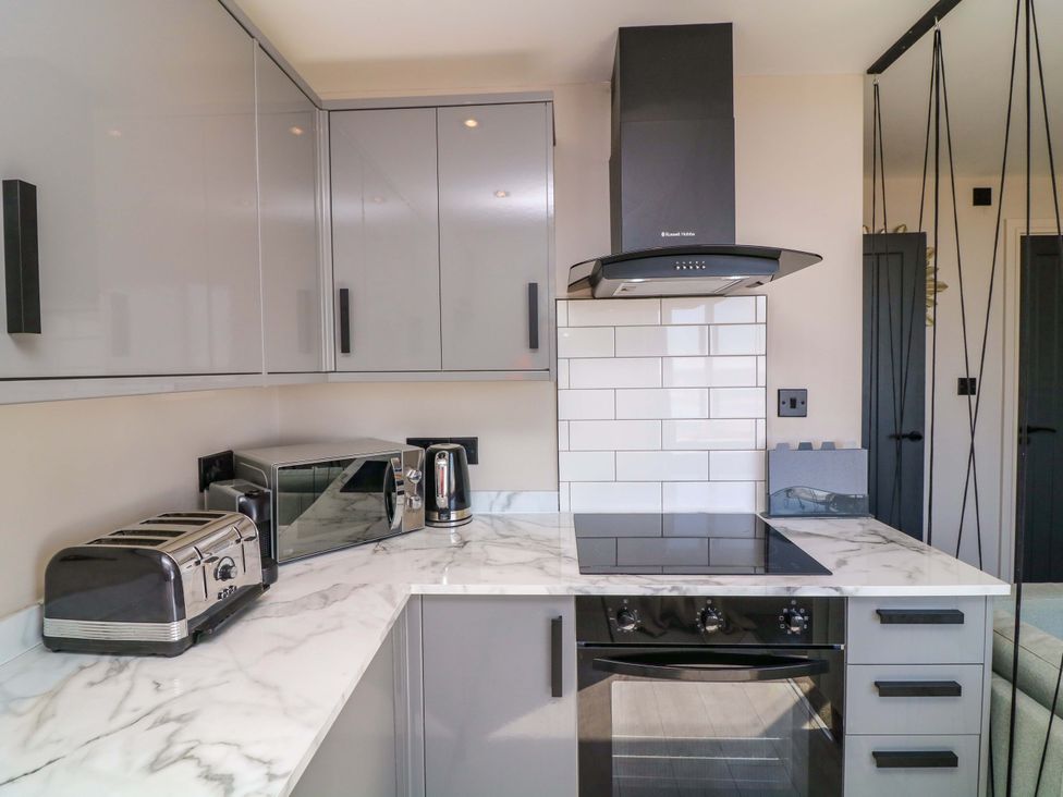 A kitchen with appliances including a microwave and toaster at Apt 8 @ Hunter's Quay in Bridlington
