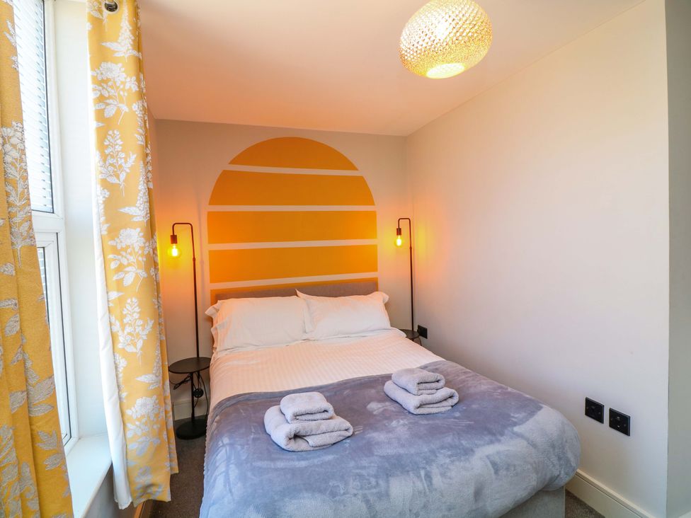 A bedroom with a bed and lamps at Apt 8 @ Hunter's Quay, Bridlington