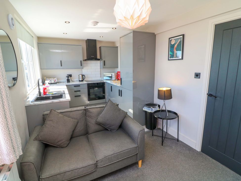 A kitchen with a sofa in the corner at Apt 9 @ Hunter's Quay, Bridlington