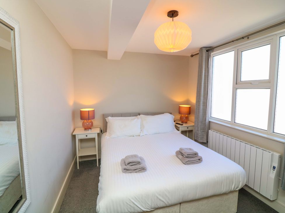 A bedroom with a double bed and bedside tables at Apt 9 @ Hunter's Quay Bridlington