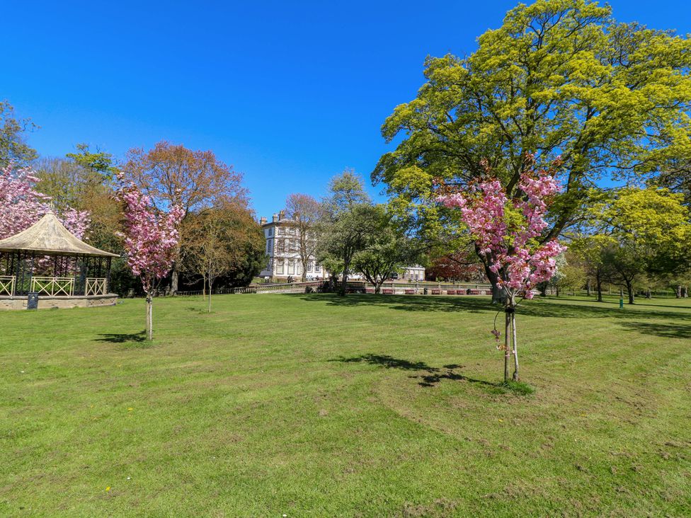 A park with a bandstand and flowering trees at Apt 9 @ Hunter's Quay Bridlington