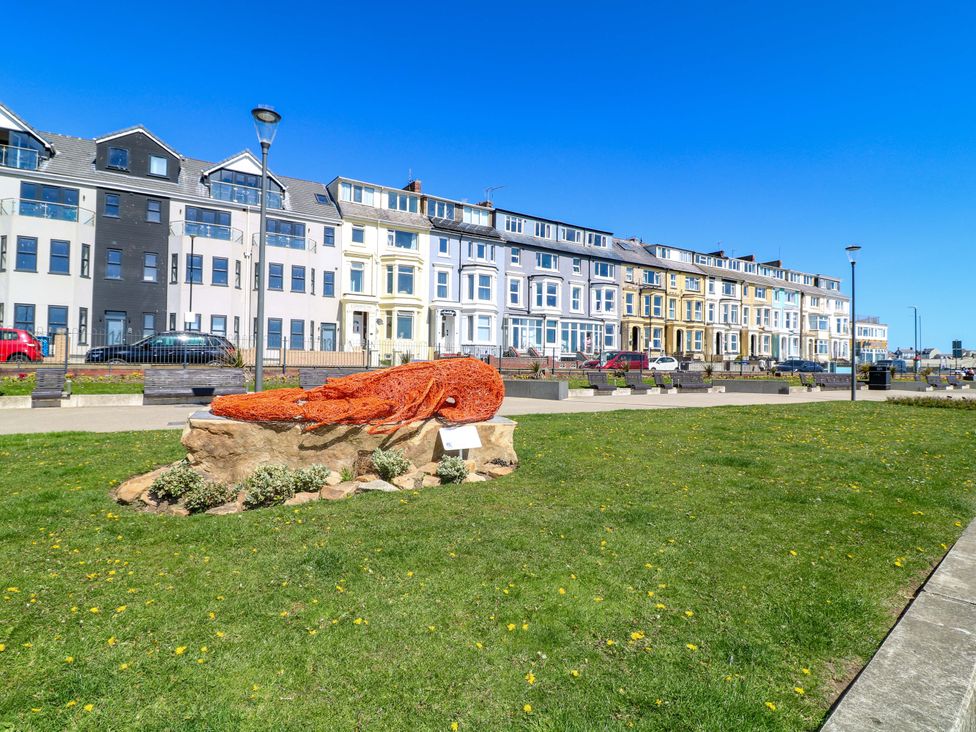 A lobster sculpture in a park with buildings in the background at Apt 10 @ Hunter's Quay, Bridlington