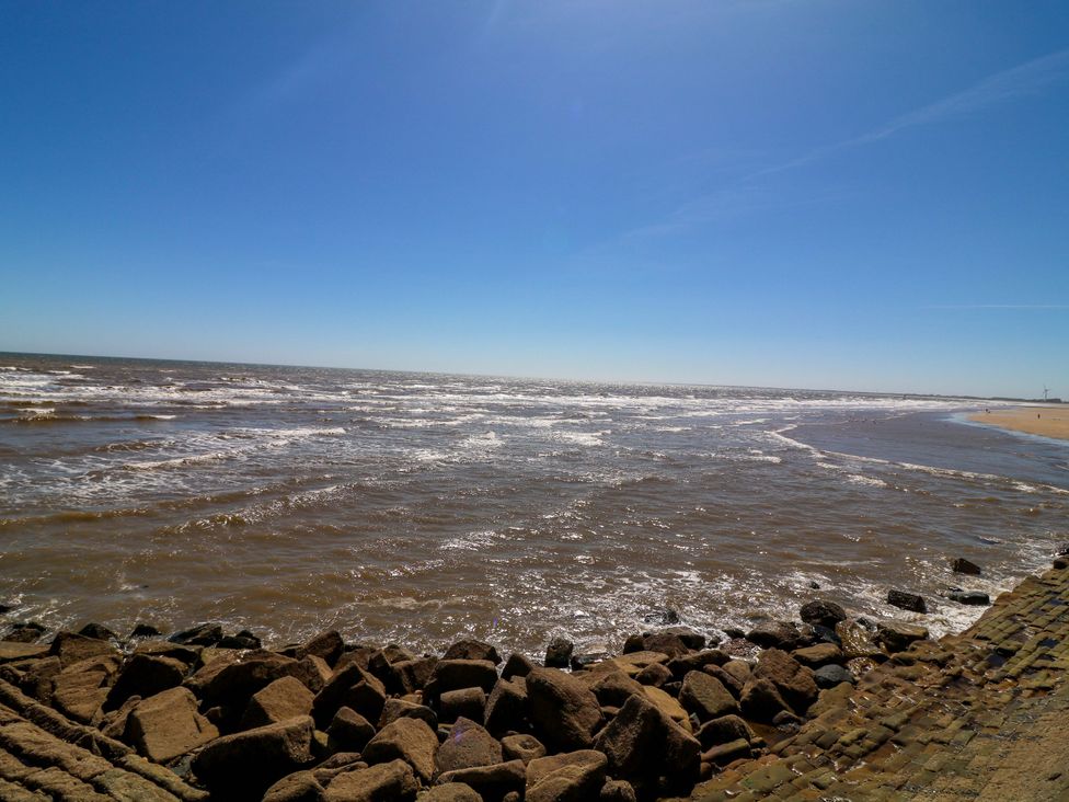 A view of the ocean with waves and rocks at Apt 10 @ Hunter's Quay, Bridlington
