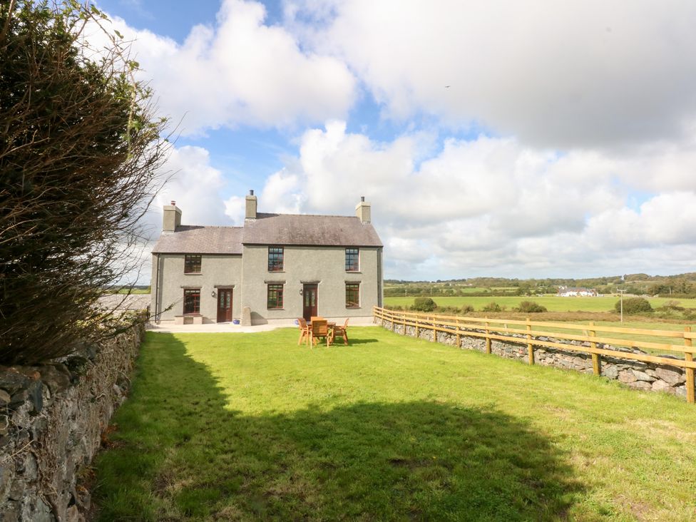 A house with a garden and chairs on the lawn at Trefor Ganol Beaumaris