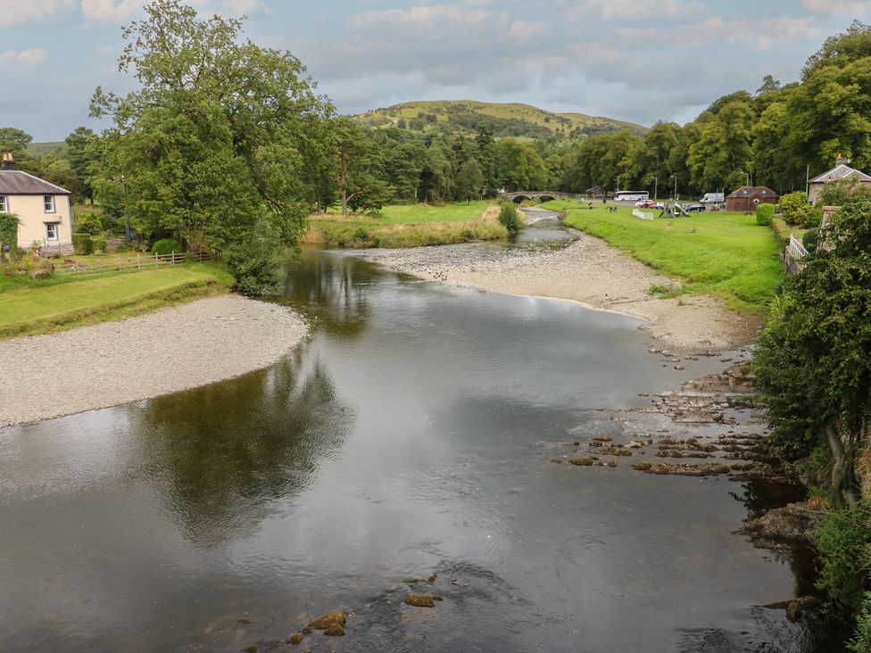 A river with trees and a house near the bank at Eskvale House Langholm