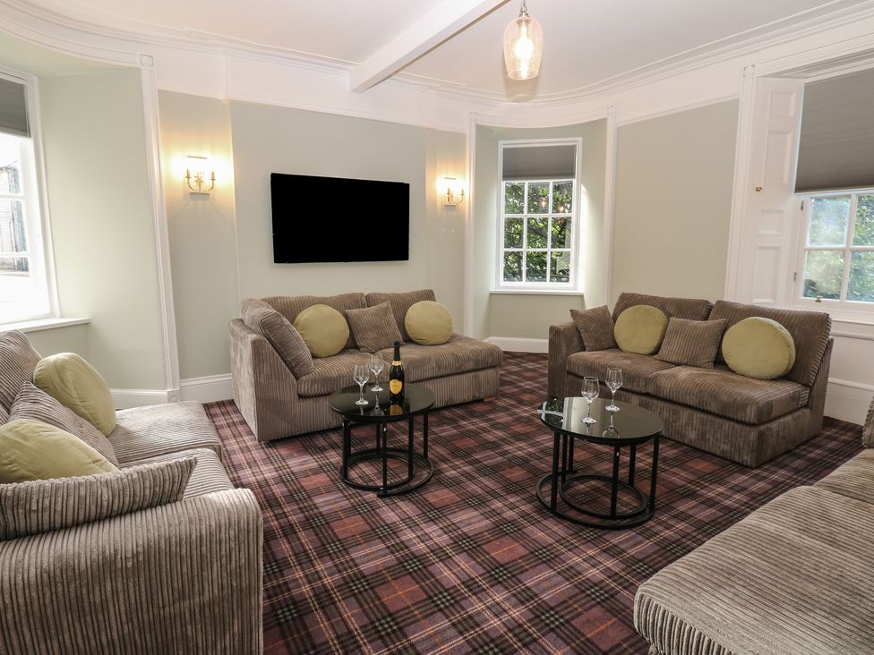 A living room with sofas and a coffee table at Eskvale House in Langholm