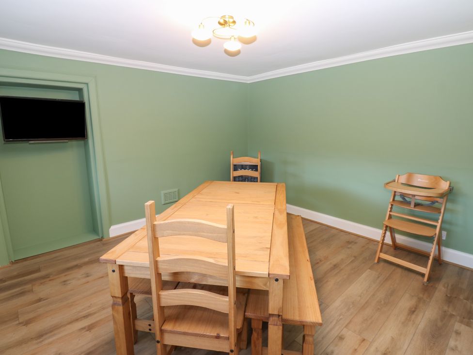 A dining room with a table and chairs at Eskvale House in Langholm