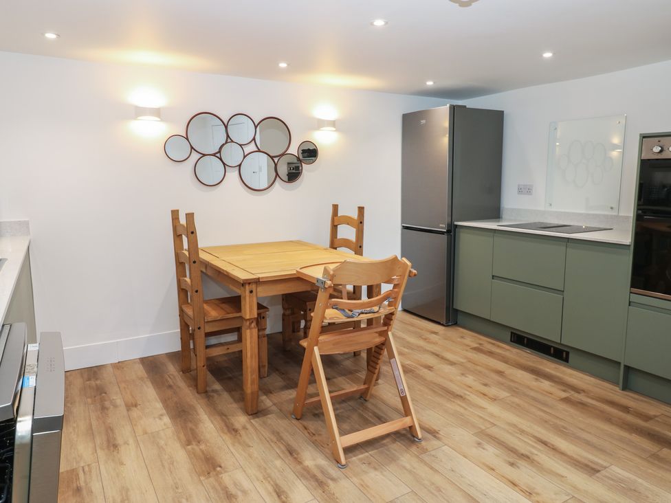 A kitchen with a table and chairs at Eskvale House in Langholm