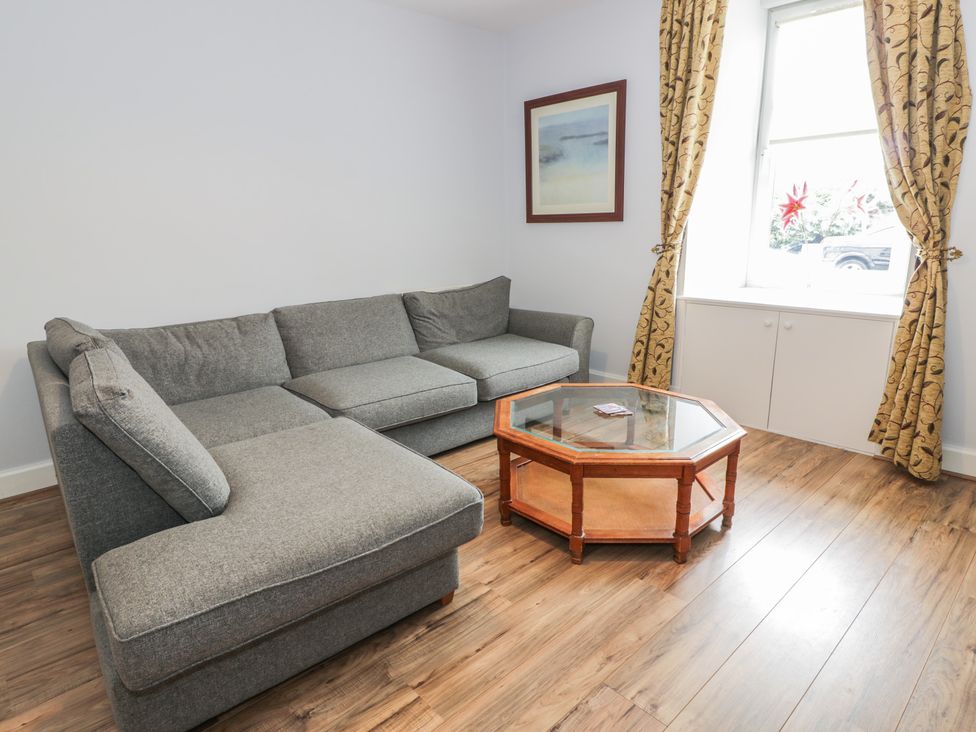 A living room with a sofa and a table at King's Apartment