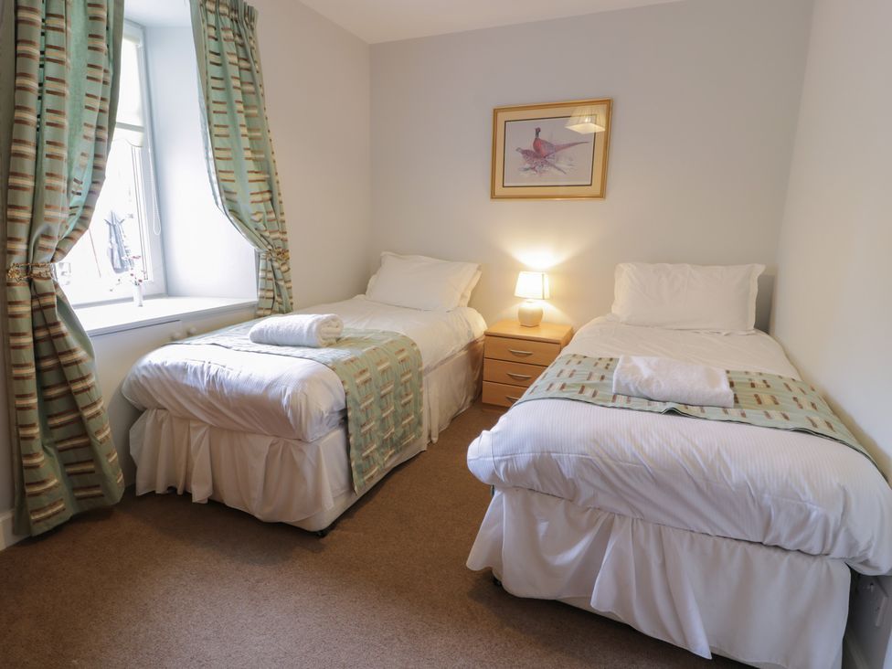 A bedroom with two beds and a window at King's Apartment