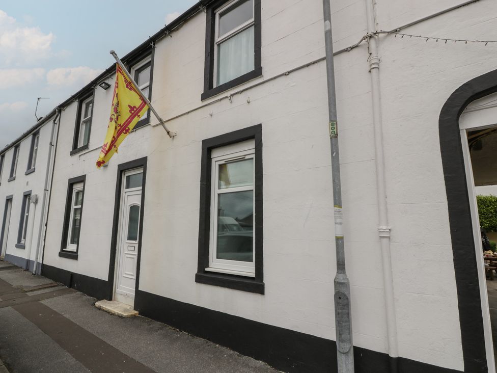 An exterior view of a building with a flag at King's Apartment