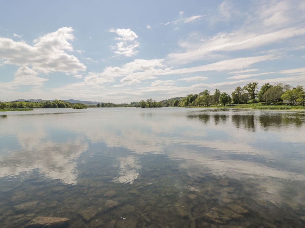 A scenic view of water reflecting clouds and trees at King's Apartment