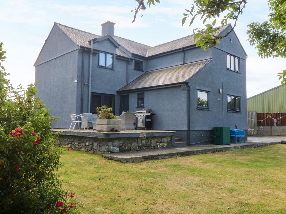 A house with a terrace and outdoor seating at Tyn Rallt Newborough
