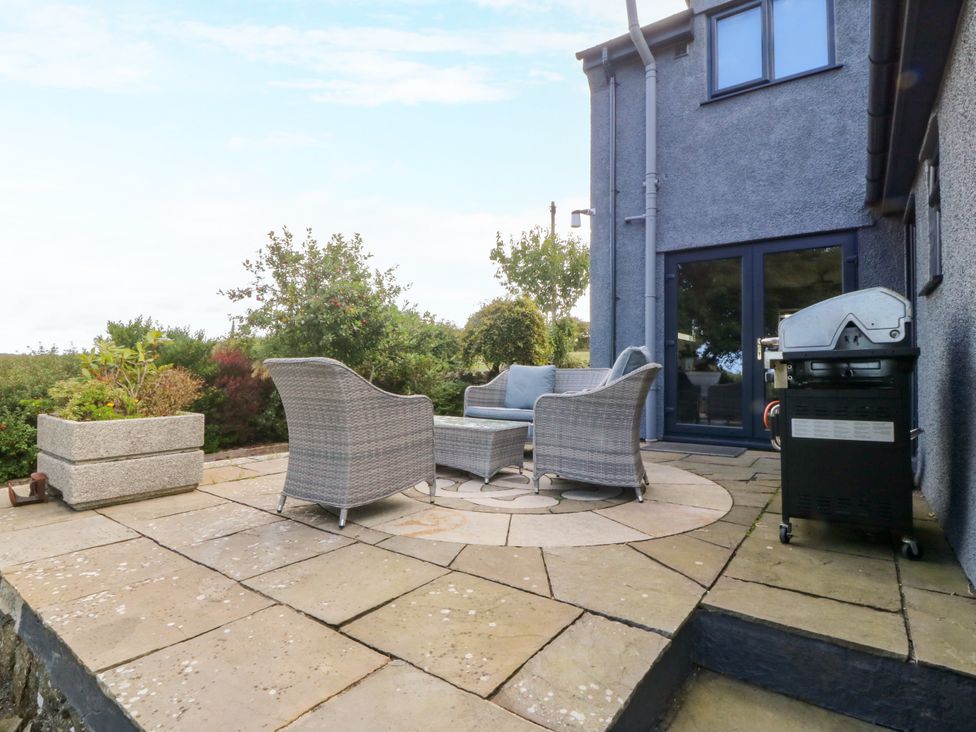 An outdoor area with seating and a grill at Tyn Rallt Newborough