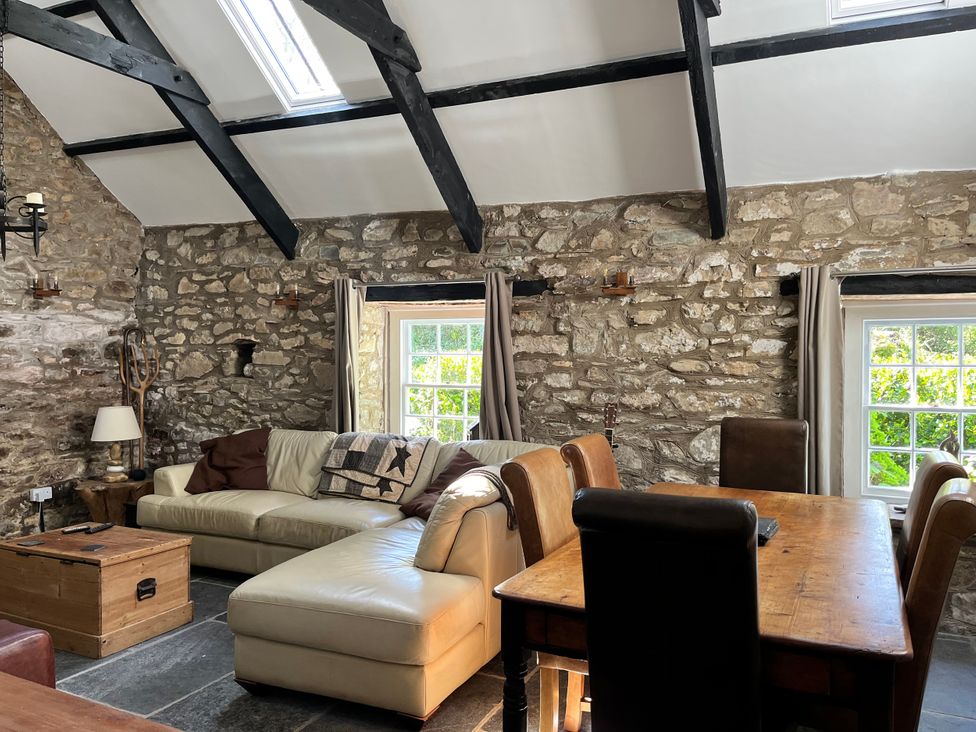 A living room with a sofa and dining table at Glas y Dorlan Nevern near Newport, Pembrokeshire