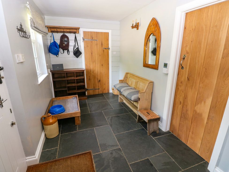 A hallway with a coat rack and a bench at Glas y Dorlan Nevern near Newport, Pembrokeshire