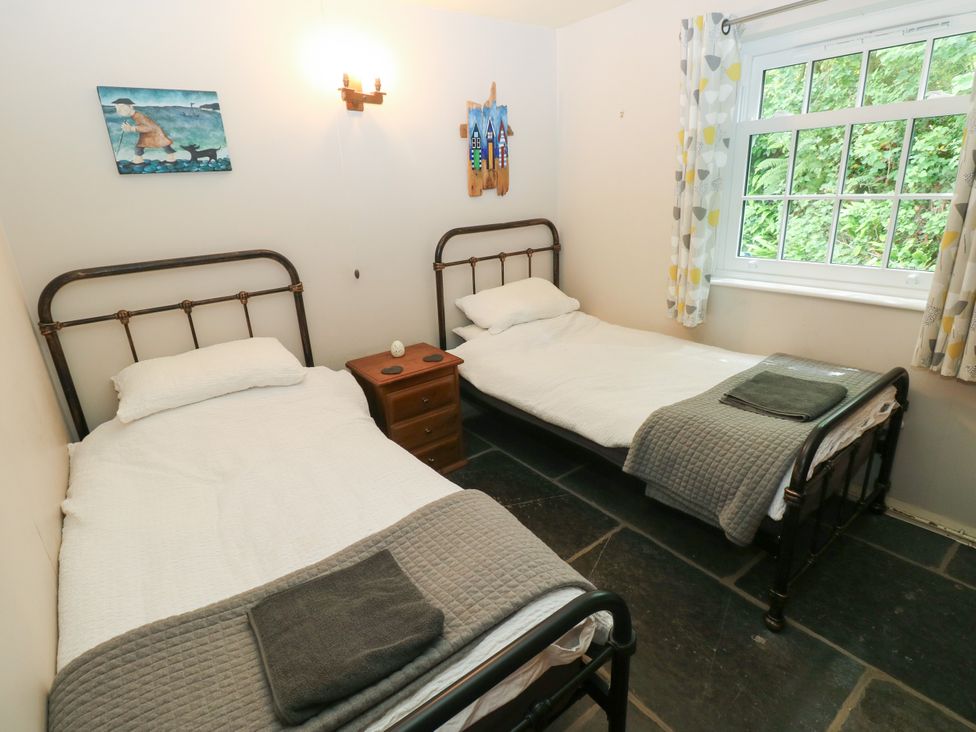 A bedroom with two single beds and a window at Glas y Dorlan Nevern near Newport, Pembrokeshire